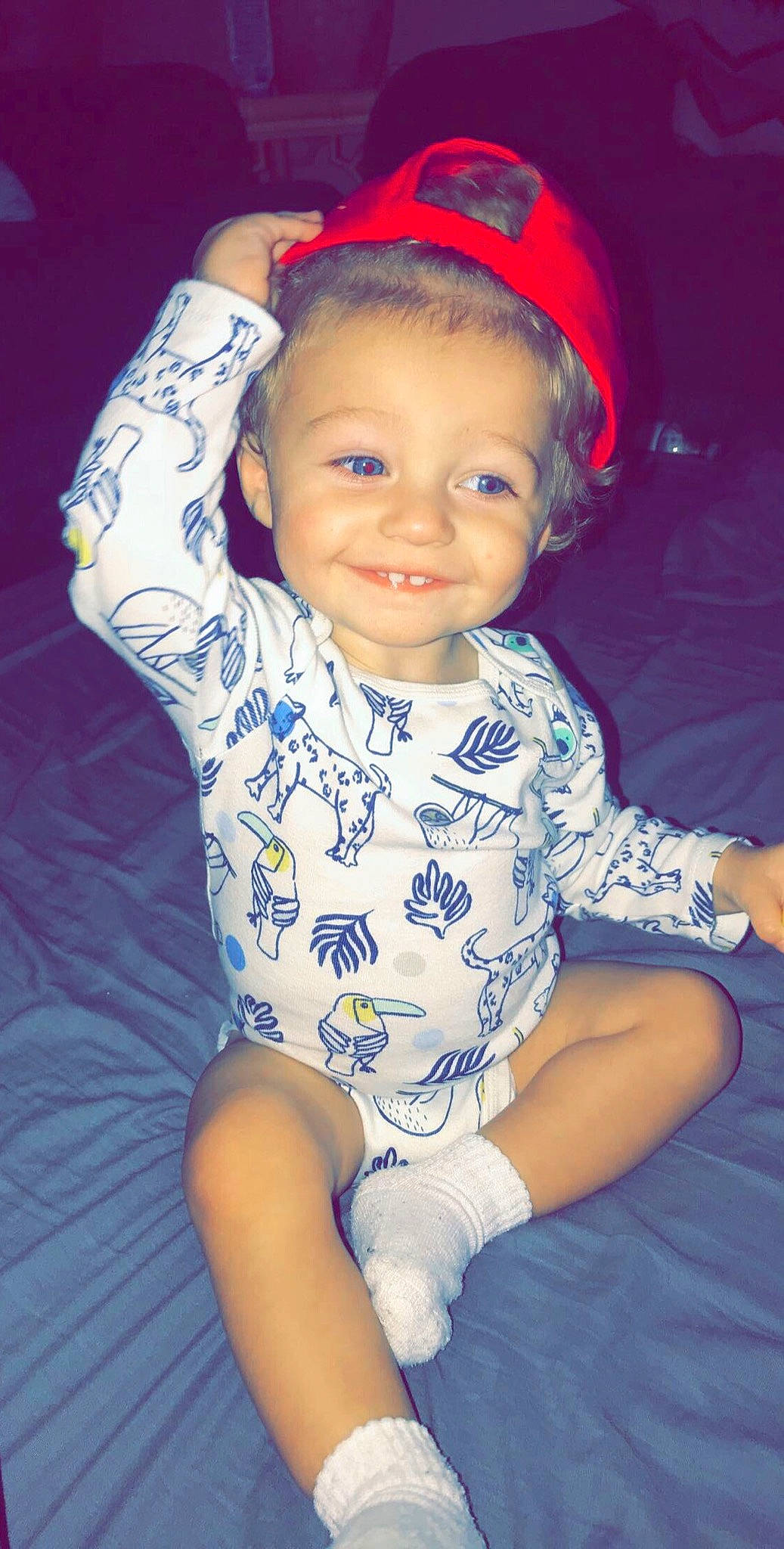 Seven is registered to the contest to win money with this photo: arm, baby, cheek, child, child_model, eye, face, fun, head, headgear, iris, joy, lip, person, sitting, skin, smile, toddler