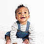 Khionyx joined the competition — help win amazing prizes! baby, child, smile, happy, denim_overalls, striped_shirt, curly_hair, sitting, white_background, fluffy_rug, cute, portrait, young_child, indoors, innocence, joy, expression, barefoot, skin, face