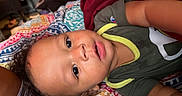 Jamar joined the competition — help win amazing prizes! baby, bed, bedspread, candid, child, close_up, clothing, curly_hair, eyes, face, family, home, indoor, infant, lying_down, patterned_fabric, portrait, shirt, shorts, smiling