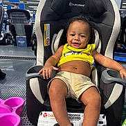 Jamar joined the competition — help win amazing prizes! baby, baby_gear, car_seat, child, face, happy, indoor, infant, pink_basket, portrait, product_display, retail, seated, shopping, shorts, showroom, smiling, store, vehicle_safety, yellow_shirt