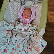 Xena is registered to the contest to win money with this photo: newborn, baby, sleeping, blanket, animal_print, rainbow, baby_sleeper, floor, wood, arms_up, cozy, infant, clothing, patterned_blanket, peaceful, indoors, cute, resting, child, soft