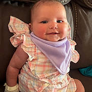 Kyomi joined the competition — help win amazing prizes! baby, infant, smile, couch, romper, bib, plaid, pastel_colors, cute, chubby_cheeks, seated, indoor, leather, furniture, child, young, happy, portrait, one_person, casual_clothing