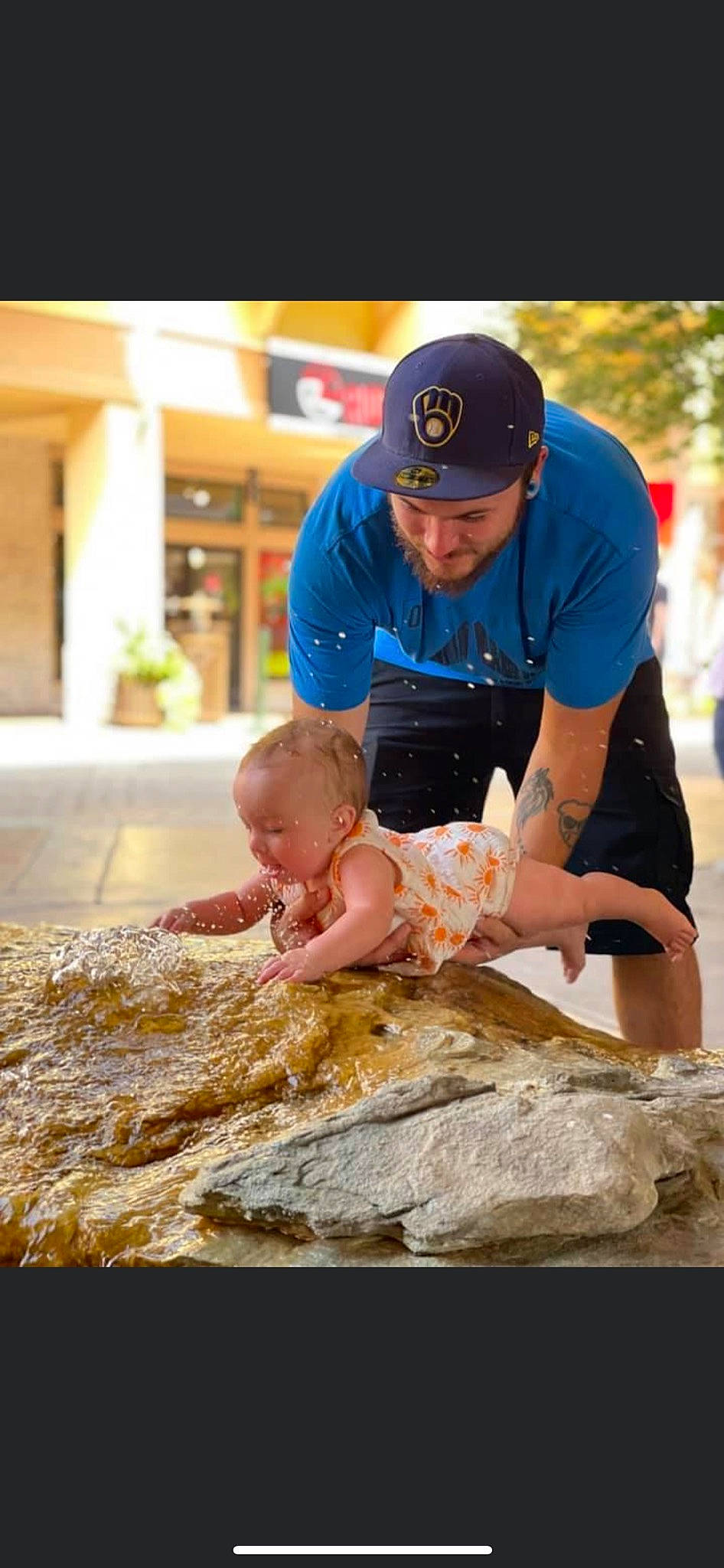 Scarlett is registered to the contest to win money with this photo: baby, baby_toddler_clothing, baseball_cap, cap, child, event, fun, happy, hat, headwear, leisure, person, plant, recreation, rock, sand, shorts, sitting, soil, t_shirt