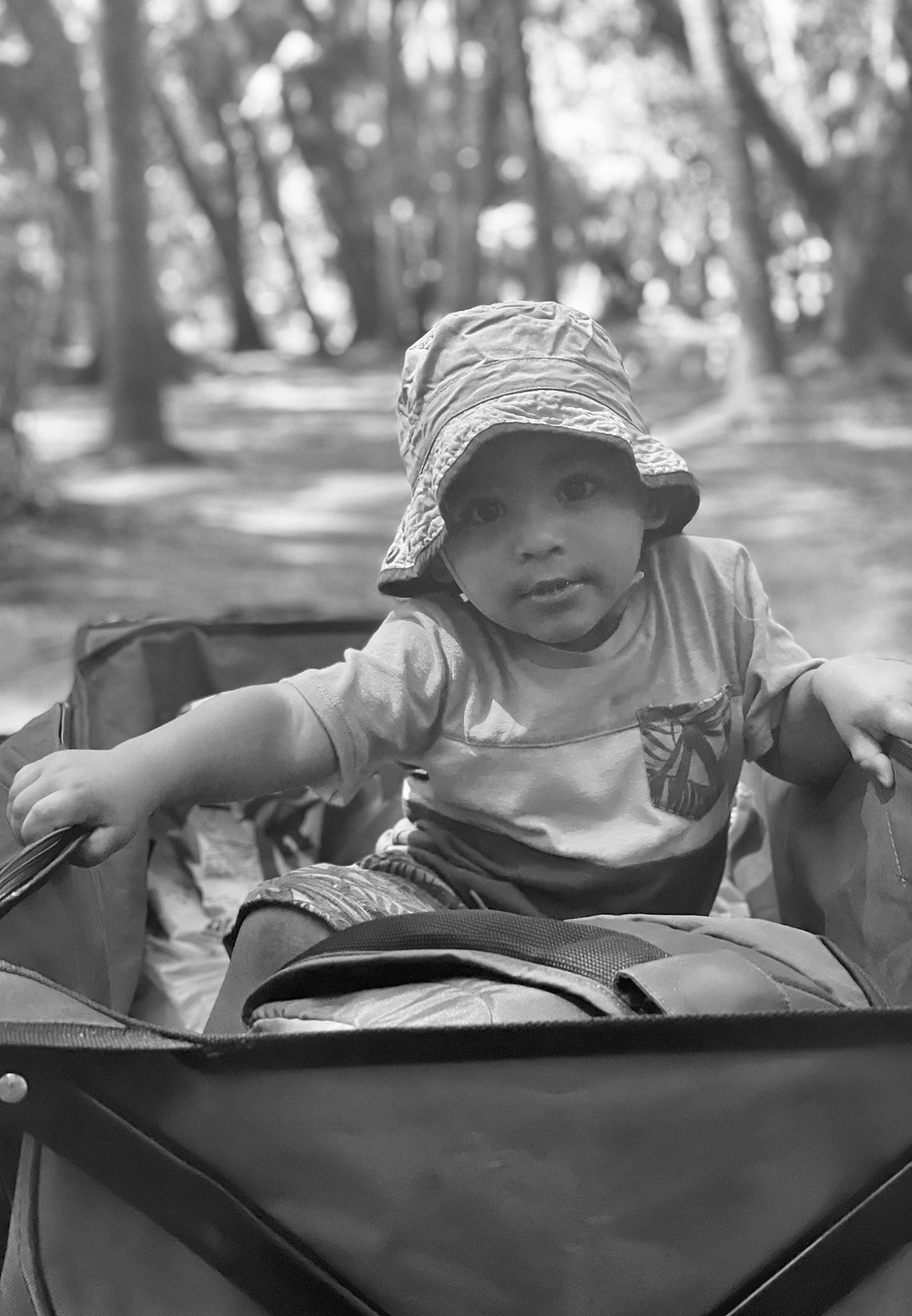 Jordin is registered to the contest to win money with this photo: baby_carriage, baby_products, black, black_and_white, child, facial_expression, fun, grass, happy, headwear, leaf, leisure, monochrome, monochrome_photography, motor_vehicle, outdoor_recreation, person, recreation, style, toddler