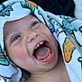child, toddler, smiling, happy, face, mouth_open, teeth, tongue, towel, colorful, blue_eyes, closeup, skin, head, expression, joy, candid, portrait, baby, cute