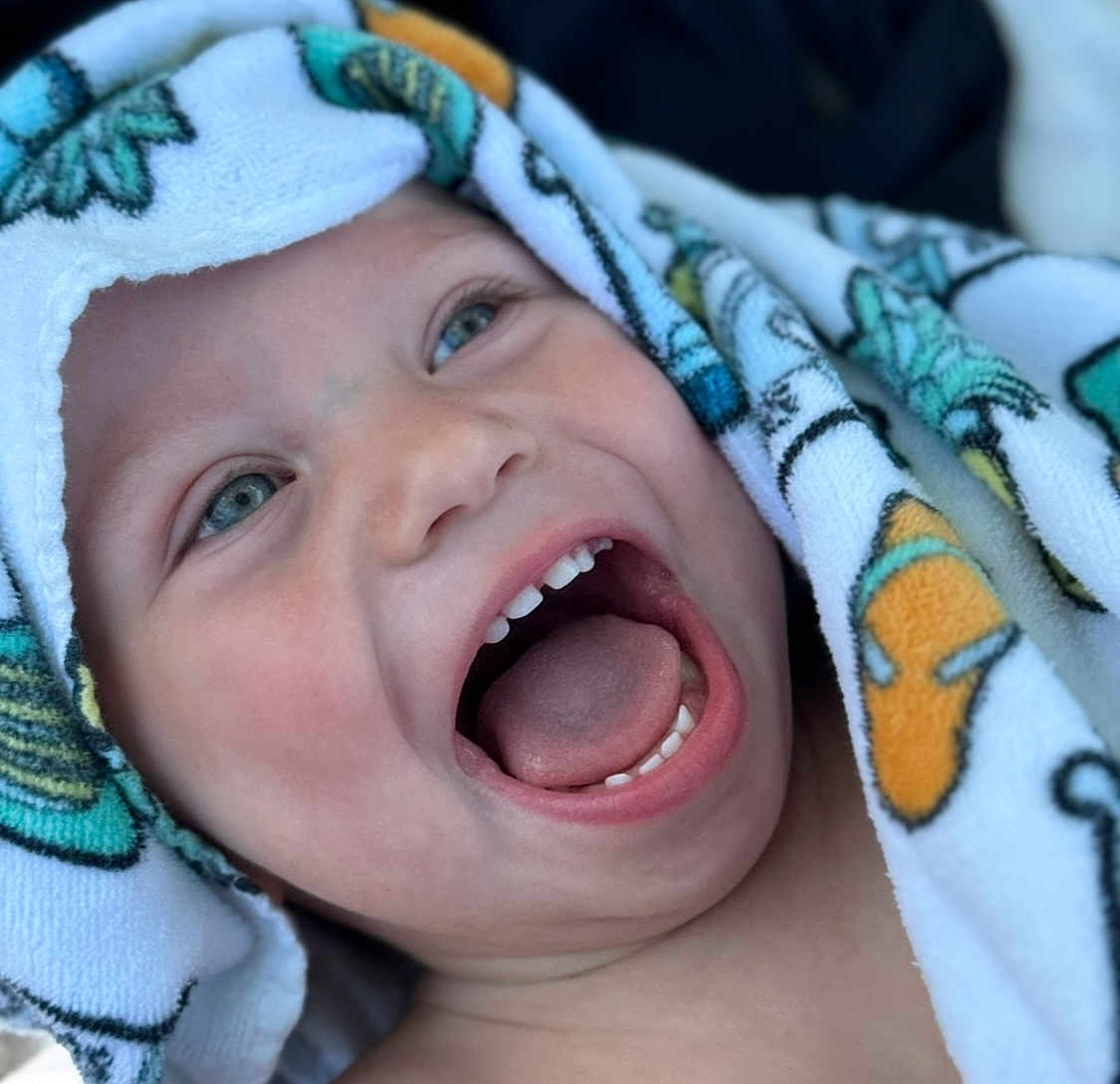 Charlie joined the competition — help win amazing prizes! child, toddler, smiling, happy, face, mouth_open, teeth, tongue, towel, colorful, blue_eyes, closeup, skin, head, expression, joy, candid, portrait, baby, cute