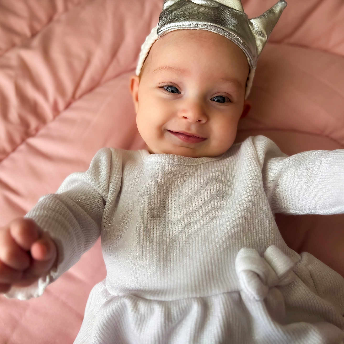 Ellie is registered to the contest to win money with this photo: baby, babylaughing, bed, bodypart, bonnet, cap, clothing, couch, face, finger, furniture, hand, happy, hat, head, newborn, person, photography, portrait, smile