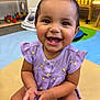 toddler, child, smiling, happy, face, dress, purple, lemons, teeth, hands, indoor, playroom, toy, colorful, seat, cute, person, skin, young, sitting