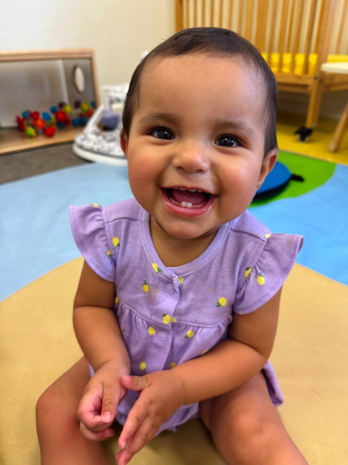Raven joined the competition — help win amazing prizes! toddler, child, smiling, happy, face, dress, purple, lemons, teeth, hands, indoor, playroom, toy, colorful, seat, cute, person, skin, young, sitting