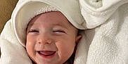 Léon participe au concours pour gagner de l'argent avec cette photo : baby, smiling, towel, hood, white, fluffy, cute, face, infant, happy, wrapped, cozy, child, portrait, skin, expression, blanket, headwear, warm, indoors