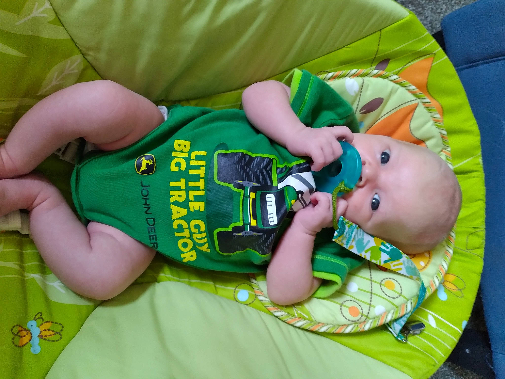 Kolton is registered to the contest to win money with this photo: baby, baby_products, baby_safety, baby_toddler_clothing, child, comfort, elbow, finger, foot, fun, grass, hand, nail, pattern, person, personal_protective_equipment, sitting, skin, sleeve, thigh