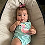 Emmily joined the competition — help win amazing prizes! baby, child, infant, onesie, pink_bow, flamingo_print, cushioned_chair, curly_hair, cute, indoors, carpet, casual, portrait, sitting, chubby_cheeks, hand, face, expression, comfortable, young_child