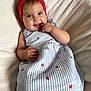 baby, child, smiling, headband, red, dress, striped, strawberry_pattern, hand, finger, lying, blanket, soft, cute, happy, portrait, indoors, skin, face, eyes