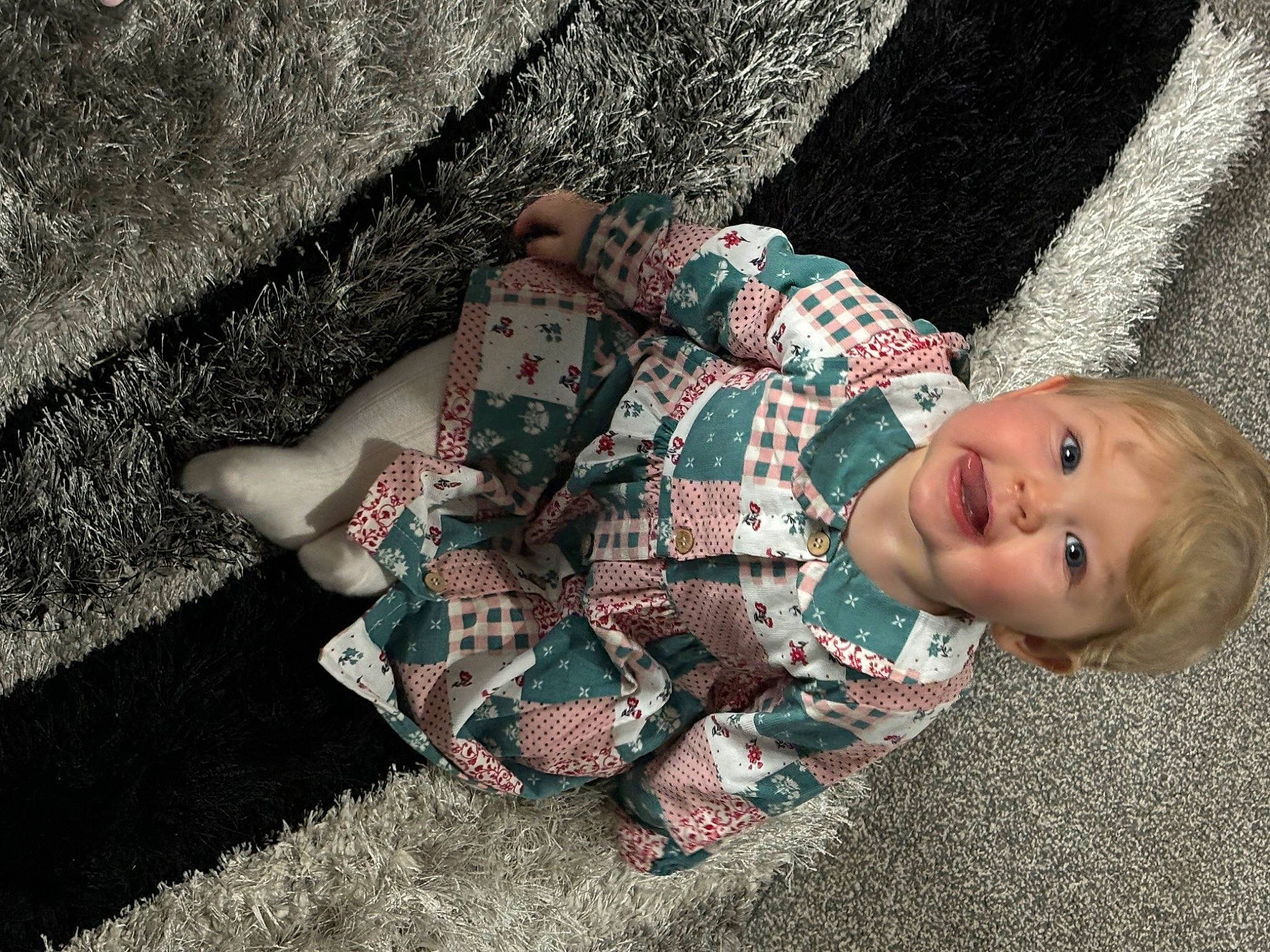 Denni-rose joined the competition — help win amazing prizes! arm, child, fashion_accessory, finger, flooring, fun, grass, hand, human_leg, pattern, person, plaid, plant, sitting, smile, soil, tartan, textile, toddler, tree