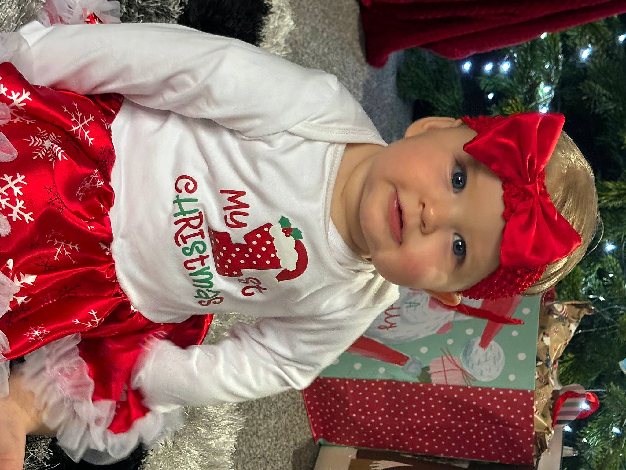Denni-rose joined the competition — help win amazing prizes! baby, baby_toddler_clothing, carmine, child, christmas, christmas_eve, event, fun, happy, hat, headwear, holiday, person, plant, red, sitting, sleeve, smile, toddler, tradition
