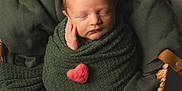 Noelle joined the competition — help win amazing prizes! newborn, baby, swaddled, blanket, green_blanket, heart, pink_heart, basket, woven_basket, leather_handles, sleeping, peaceful, infant, cute, portrait, soft_lighting, cozy, tenderness, baby_wrapped, studio_photo