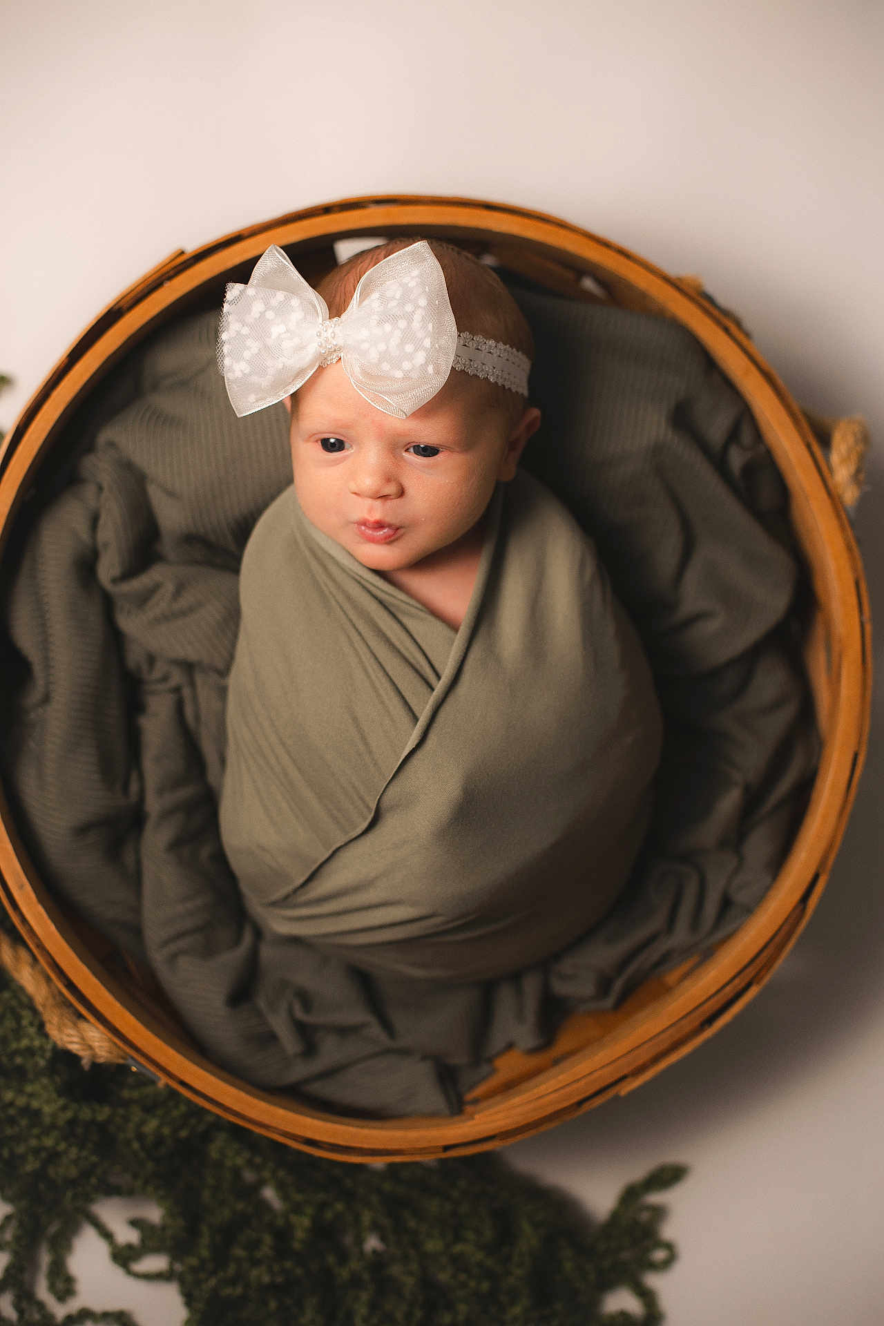 Noelle joined the competition — help win amazing prizes! baby, newborn, wrapped, blanket, headband, bow, basket, wooden_basket, curious, infant, cute, portrait, soft_lighting, cozy, baby_boy, baby_girl, child, studio, posing, smile