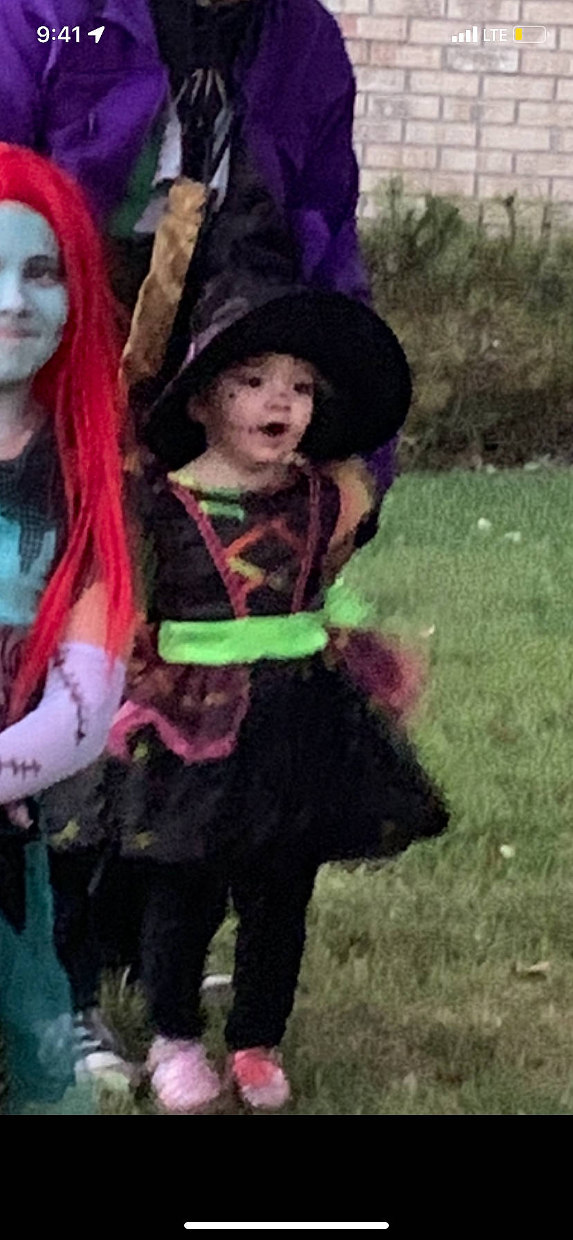 Rosalynn is registered to the contest to win money with this photo: art, costume, event, fictional_character, fun, fur, grass, hat, headgear, headwear, lawn_ornament, magenta, person, pink, plant, purple, recreation, tradition, tree, wig