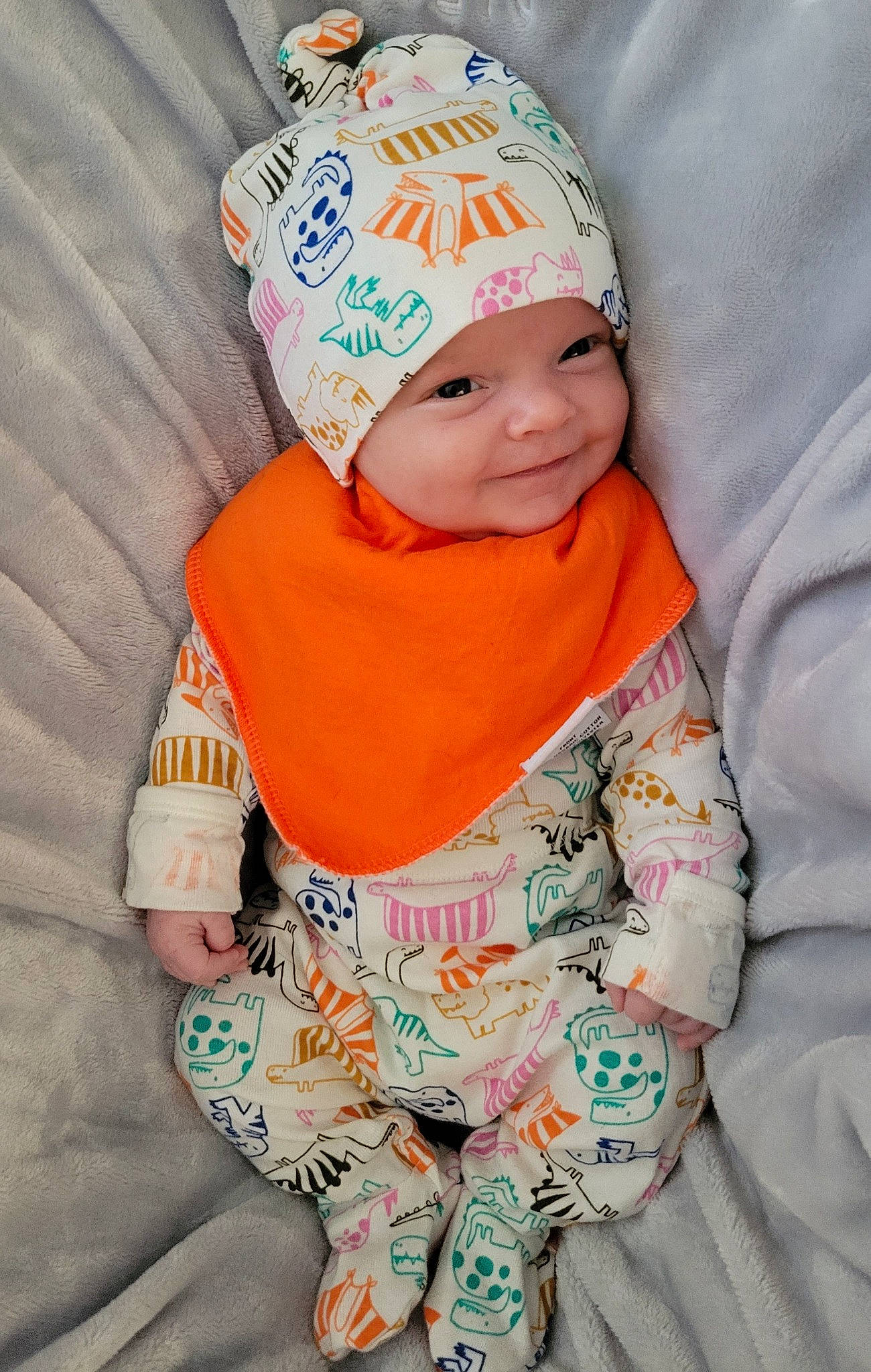 Lochlan joined the competition — help win amazing prizes! baby, baby_toddler_clothing, baseball_cap, beanie, cap, child, comfort, face, happy, hat, head, headgear, headwear, linens, orange, peach, person, sitting, skin, sleeve