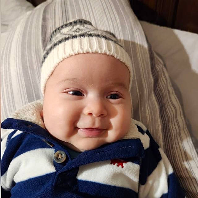 Dante is registered to the contest to win money with this photo: baby, cap, cheek, chin, close_up, comfort, eye, eyebrow, eyelash, happy, headgear, headwear, iris, lip, nose, outerwear, person, skin, sleeve, smile