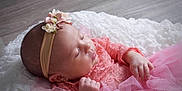 Sophie joined the competition — help win amazing prizes! baby, sleeping, infant, pink_dress, headband, flower, lace, tulle, blanket, soft_texture, peaceful, newborn, portrait, cute, child, indoor, closeup, adorable, resting, young