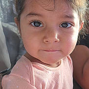 Mayle is registered to the contest to win money with this photo: child, toddler, face, close_up, portrait, pink_clothing, polka_dot, expression, skin, eyes, hair, natural_light, indoor, person, cute, young, baby, soft_light, head, curly_hair