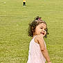 Mayle is registered to the contest to win money with this photo: child, girl, smile, outdoor, grass, greenery, playful, curly_hair, pink_clothing, happy, field, person, daylight, casual, young_child, standing, nature, fun, park, two_children