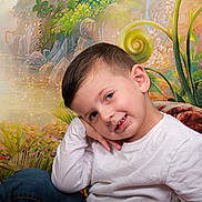 Julian a rejoint le concours — aidez-le/la à gagner de superbes lots ! child, boy, portrait, pose, white_shirt, blue_jeans, smile, face, hair, nature_background, plants, greenery, colorful, whimsical, cute, young, studio_photo, casual_clothing, happy, resting_head