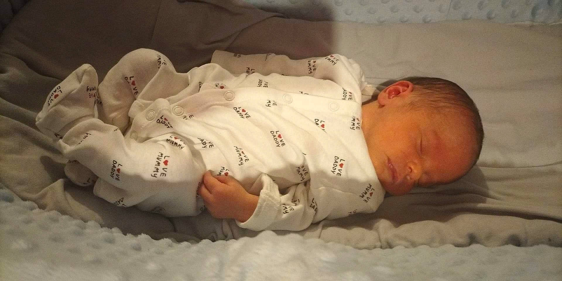 Ayyan Bahawal is registered to the contest to win money with this photo: baby, baby_sleeping, baby_toddler_clothing, bed, bedding, bedtime, carmine, child, comfort, eye, face, human_body, linens, mammal, nap, person, room, skin, sleeve, textile