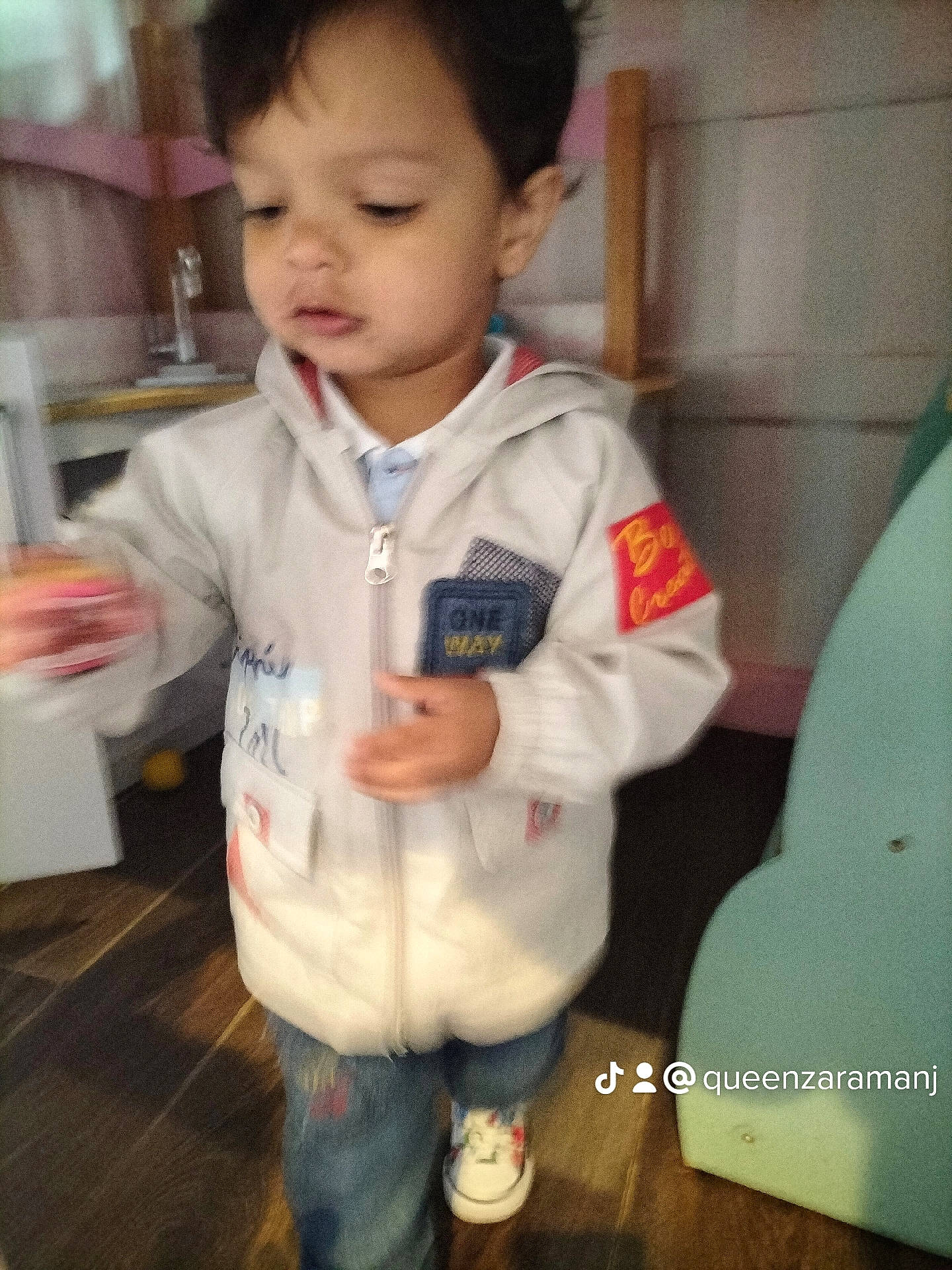 Dawood is registered to the contest to win money with this photo: baby, baby_toddler_clothing, cheek, child, denim, eyelash, flooring, fun, gesture, happy, nose, person, room, sitting, skin, sleeve, t_shirt, thumb, toddler