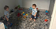Leon And Deon is registered to the contest to win money with this photo: child, toddler, indoor, carpet, toy, pacifier, baby_gate, floor, room, furniture, clothing, barefoot, playtime, person, young_child, plush, matching_outfits, window, shelf, blank_wall
