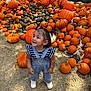 toddler, child, pumpkins, autumn, outdoor, hay, smiling, happy, overalls, denim, shoes, festival, fall, orange, green, nature, person, cute, playful, seasonal