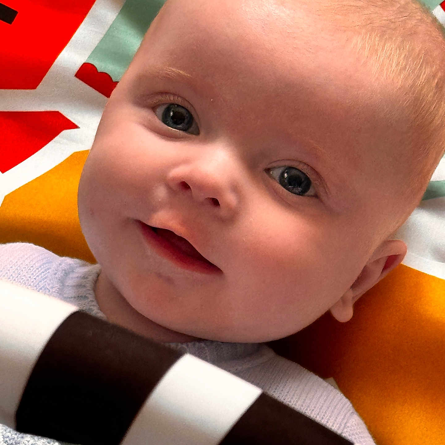 Charlie joined the competition — help win amazing prizes! baby, blanket, bodypart, clothing, crib, face, finger, furniture, hand, happy, head, infantbed, mouth, newborn, person, photography, portrait, quilt, smile, t_shirt