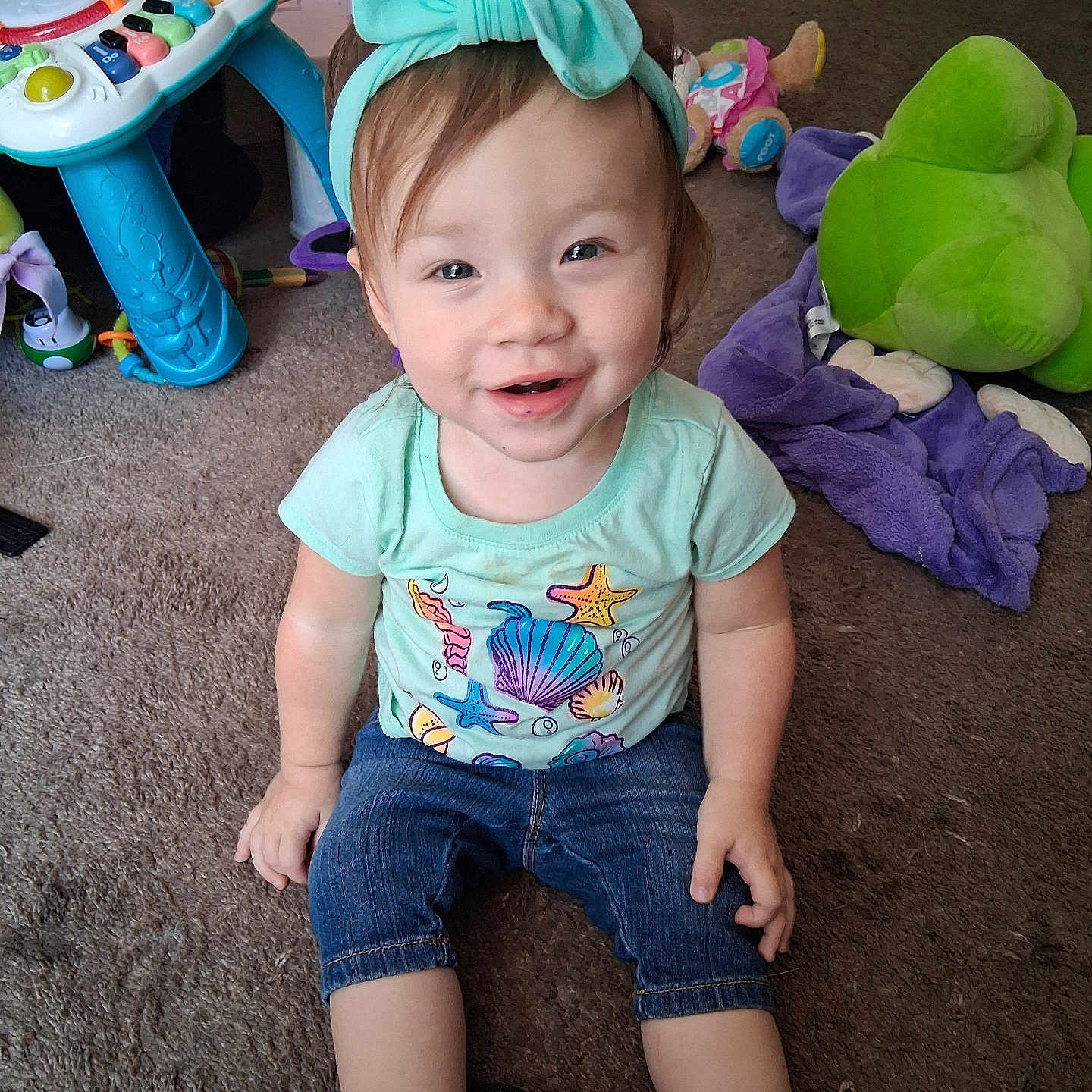 Jade joined the competition — help win amazing prizes! bow, carpet, casual_clothing, child, colorful, cute, floor, happy, headband, indoor, jeans, person, playtime, shirt, shoes, smiling, socks, toddler, toy, young