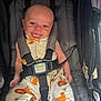 baby, smiling, stroller, child, infant, happy, clothing, lion_pattern, seatbelt, cute, person, safety_harness, small_child, fabric, infant_clothes, head, face, tongue_out, sitting, indoors
