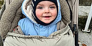 Sacha participe au concours pour gagner de l'argent avec cette photo : baby, cap, clothing, coat, face, footwear, happy, hat, head, hood, hoodie, jacket, knitwear, person, photography, portrait, shoe, smile, stroller, sweater