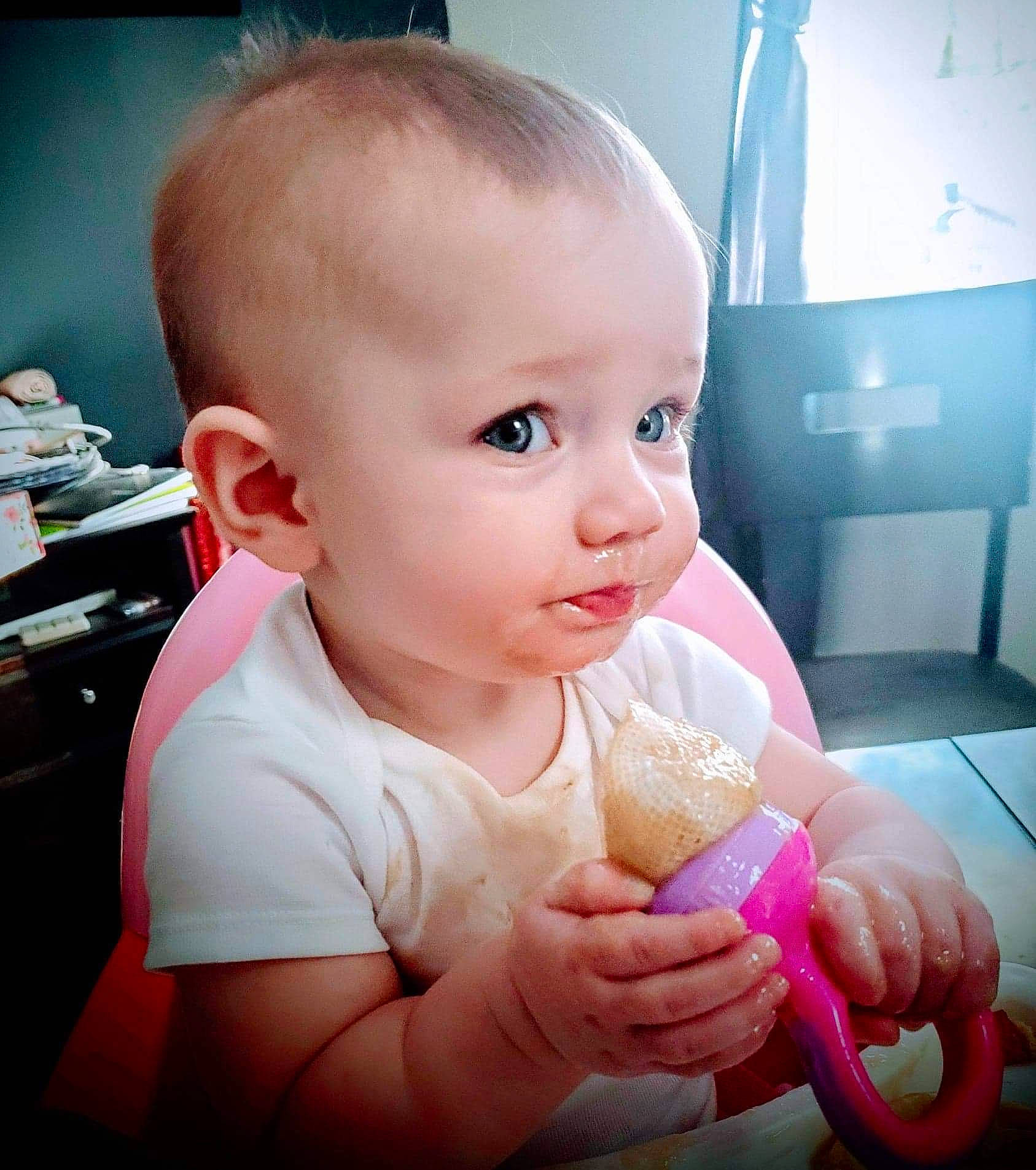 Melody is registered to the contest to win money with this photo: arm, baby, baby_products, baby_toddler_clothing, chest, child, drinkware, eyelash, food, gesture, hand, happy, lip, nail, nose, person, product, skin, television, thumb