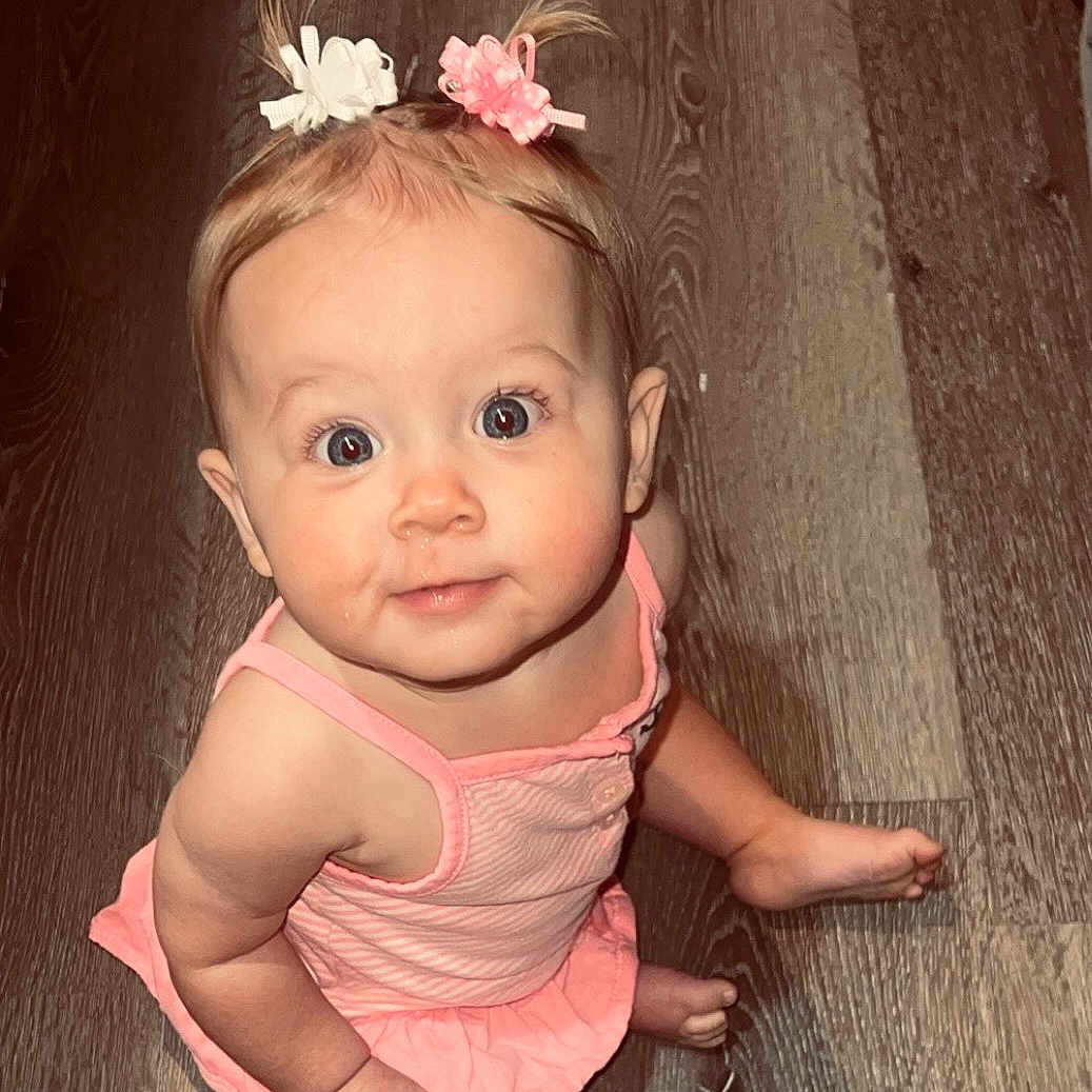 Kinzlee is registered to the contest to win money with this photo: accessories, baby, barefoot, bodypart, clothing, crawling, dress, earring, face, finger, flower, hand, head, jewelry, newborn, person, photography, portrait, sitting, wood