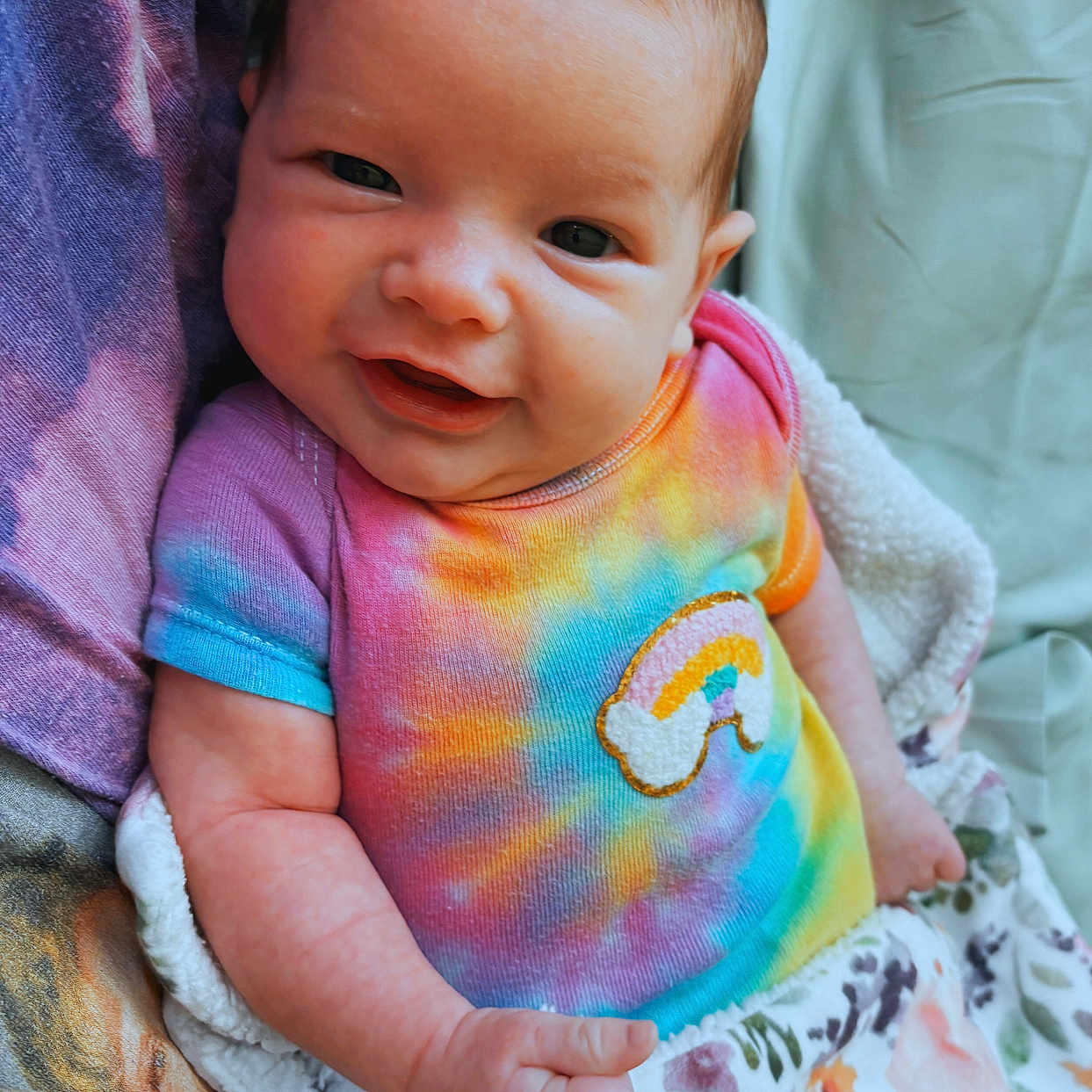 Elsie is registered to the contest to win money with this photo: baby, blanket, bodypart, clothing, cushion, dress, face, finger, furniture, happy, head, homedecor, newborn, person, photography, portrait, quilt, smile, t_shirt, towel