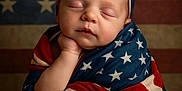 Oakleigh joined the competition — help win amazing prizes! baby, infant, sleeping, flag, american_flag, patriotic, headband, bow, wrapped, portrait, closeup, peaceful, cute, face, hand, skin, child, background, red, blue