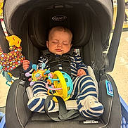 Oakleigh joined the competition — help win amazing prizes! baby, infant, car_seat, graco, striped_clothing, sleeping, toy, colorful_toy, child, shopping_cart, store, seatbelt, baby_clothes, footwear, headrest, indoor, floor, person, cute, resting