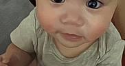 Anakin Lucas joined the competition — help win amazing prizes! baby, infant, child, portrait, sitting, wide_eyes, serious_expression, face, indoor, home, couch, clothing, shirt, short_sleeves, bare_arms, brown_hair, gray_shirt, close_up, photography, safe