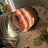 Anakin Lucas is registered to the contest to win money with this photo: baby, bedding, crib, crib_sheet, face, grinning, happy, indoor, infant, leaf_pattern, lying_down, nursery, pacifier, pajamas, portrait, shadows, smiling, striped_clothing, sunlight, toy