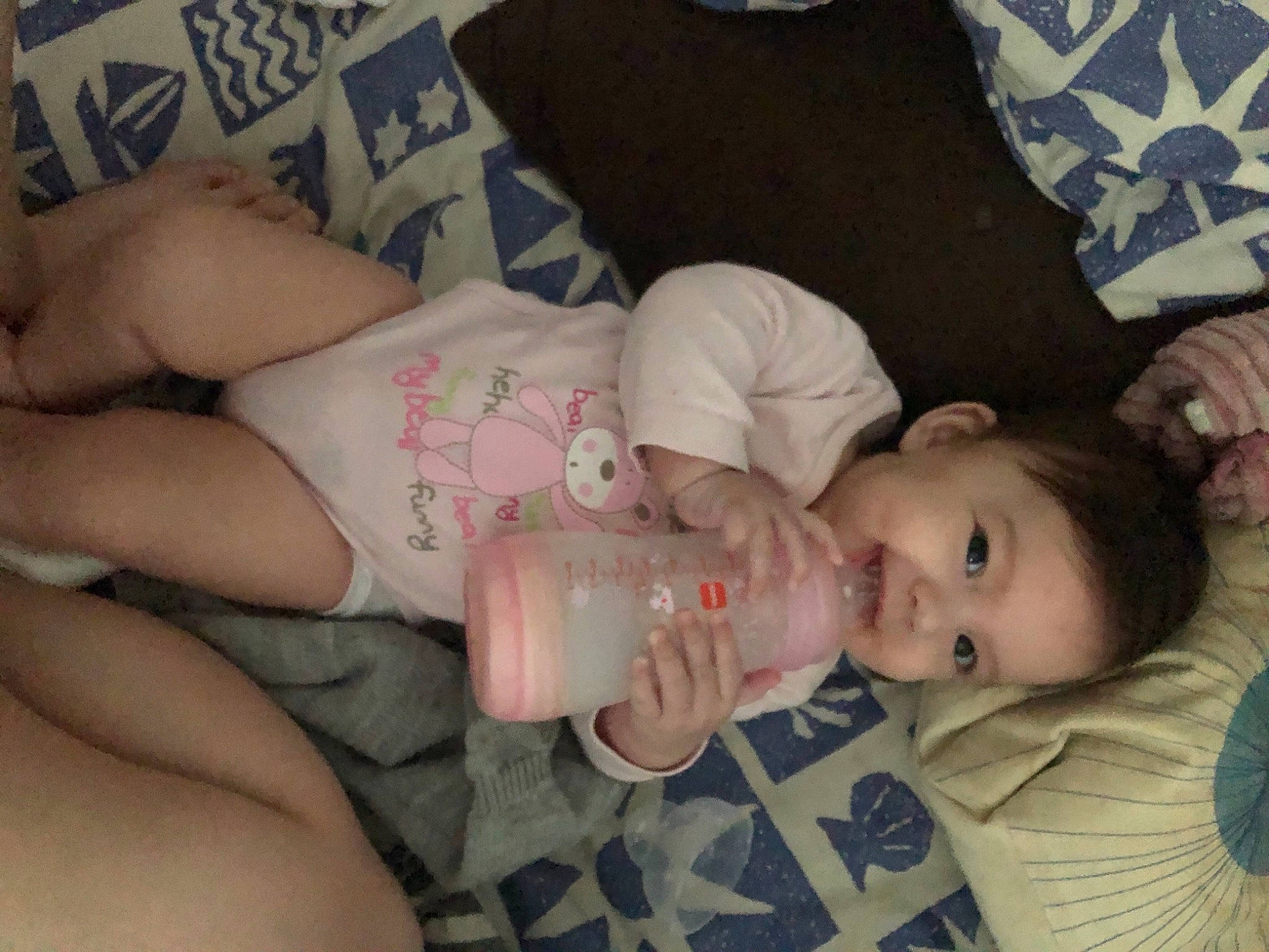 Malya participe au concours pour gagner de l'argent avec cette photo : arm, baby, baby_toddler_clothing, cheek, chest, child, comfort, drinkware, eyelash, finger, hand, human_body, lip, mouth, nail, person, room, skin, smile, textile