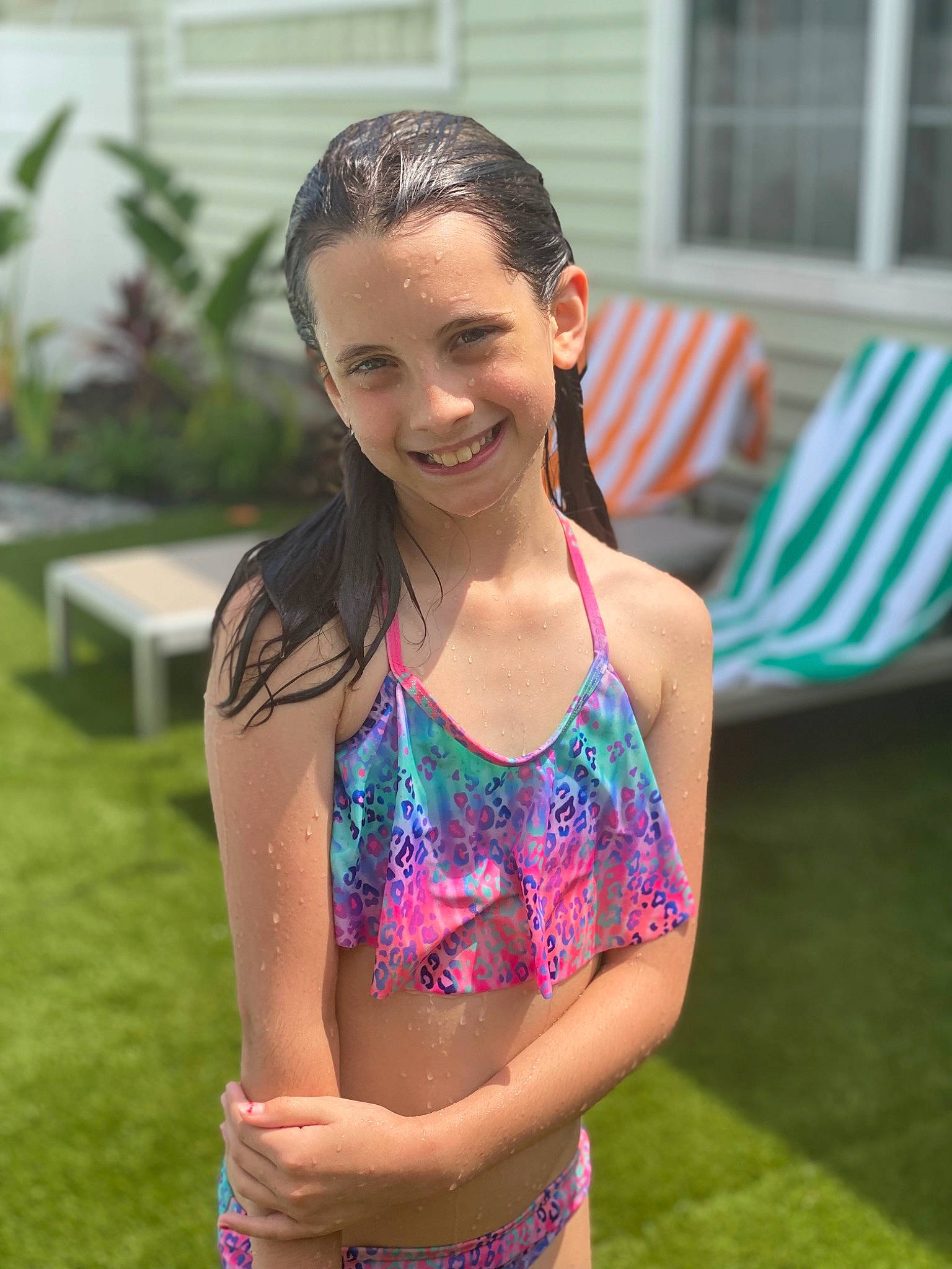 Madison is registered to the contest to win money with this photo: abdomen, brown_hair, chest, electric_blue, face, fun, grass, happy, human_leg, joy, leisure, long_hair, person, plant, recreation, smile, swimsuit_top, swimwear, thigh, trunk