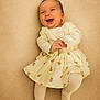Kyara a rejoint le concours — aidez-le/la à gagner de superbes lots ! baby, infant, smiling, laughing, clothing, dress, skirt, tights, portrait, cute, child, happy, indoors, one_person, human, apparel, laying_down, background, soft, light