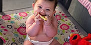 Angélique joined the competition — help win amazing prizes! baby, bright, child, colorful, cute, diaper, elmo, floor, happy, indoors, infant, panda, patterned, play, playpen, plush_toy, sitting, smiling, teething_toy, toys