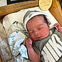 Jaelyn joined the competition — help win amazing prizes! newborn, baby, sleeping, infant, blanket, hospital_bassinet, clothing, hat, face, person, wooden_plaque, name_tag, nike, peaceful, cute, indoor, soft_lighting, resting, closeup, hospital