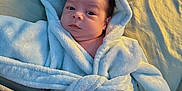 Jaelyn joined the competition — help win amazing prizes! baby, infant, robe, hood, blue, bed, blanket, soft, cute, face, skin, person, lying, comfort, indoors, child, young, expression, warm, sleepwear