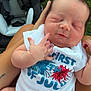 Jaelyn is registered to the contest to win money with this photo: baby, newborn, infant, sleeping, onesie, hand, face, skin, person, outdoor, grass, car_seat, clothing, tattoo, legs, lap, celebration, holiday, closeup, peaceful